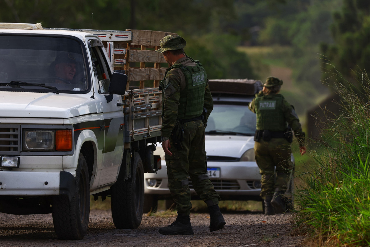  Agents of the Environmental Patrol of the Military Brigade (PATRAM) check vehicles close to a commercial poultry farm, the site of the country's first bird flu outbreak, in Montenegro, Rio Grande do Sul state, Brazil, on May 17, 2025. China and the European Union have suspended imports of chicken meat from Brazil, the world's biggest exporter of the commodity, after an outbreak of bird flu on a farm in the South American country, officials said Friday. 