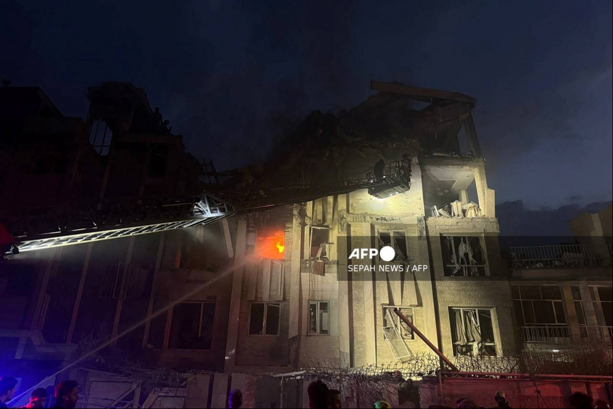  This handout photo released by Iran's Revolutionary Guard Corps (IRGC) official Sepah News Telegram channel on June 13, 2025 reportedly shows a building in Tehran hit in an Israeli strike on the Iranian capital early in the morning. Israeli Prime Minister Benjamin Netanyahu said in a video statement in the early hours of June 13 that Israel carried out strikes on Iran and the military operation against the Islamic republic would  